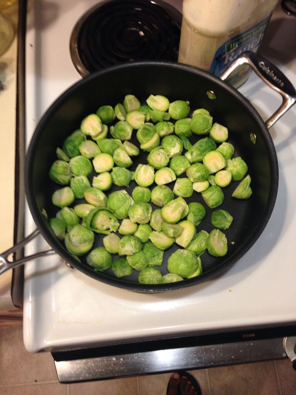 Cup Brussels sprouts in half and remove outer leaves. Add garlic to pan and satay.