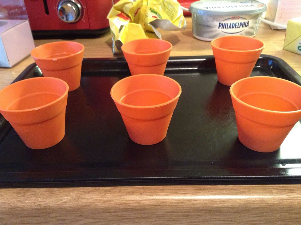 Cupcake case flower pots from Lakeland stores. \u00a35 for 6.  Grease with butter on the inside.