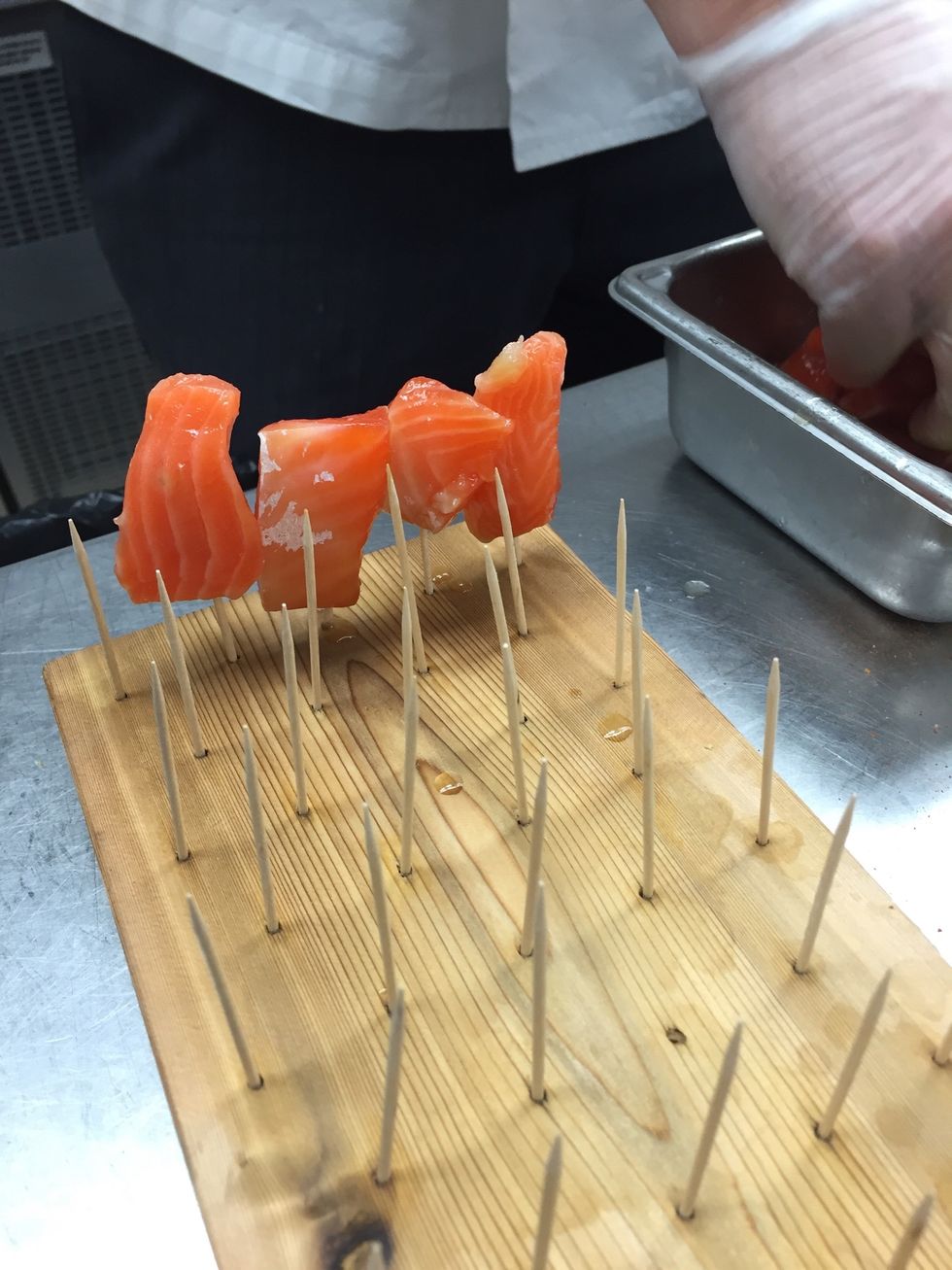 Cure salmon overnight with salt & sugar. Assemble salmon scraps in bite size pieces ( either as a presentation piece or on a sheet tray with an icing rack )