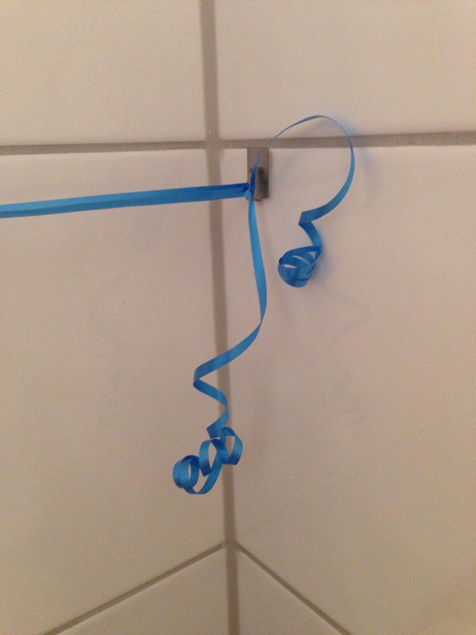 Curl it up with a scissor if you want to, or just cut it off