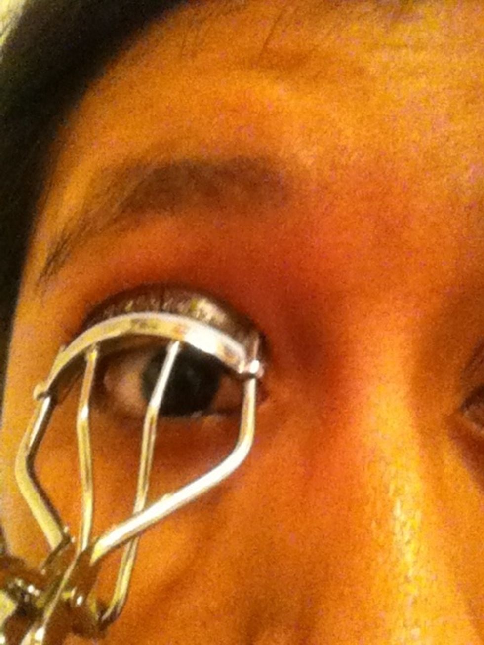 Curl your eyelashes by pushing the eyelash curler back (hold it for a couple of seconds)