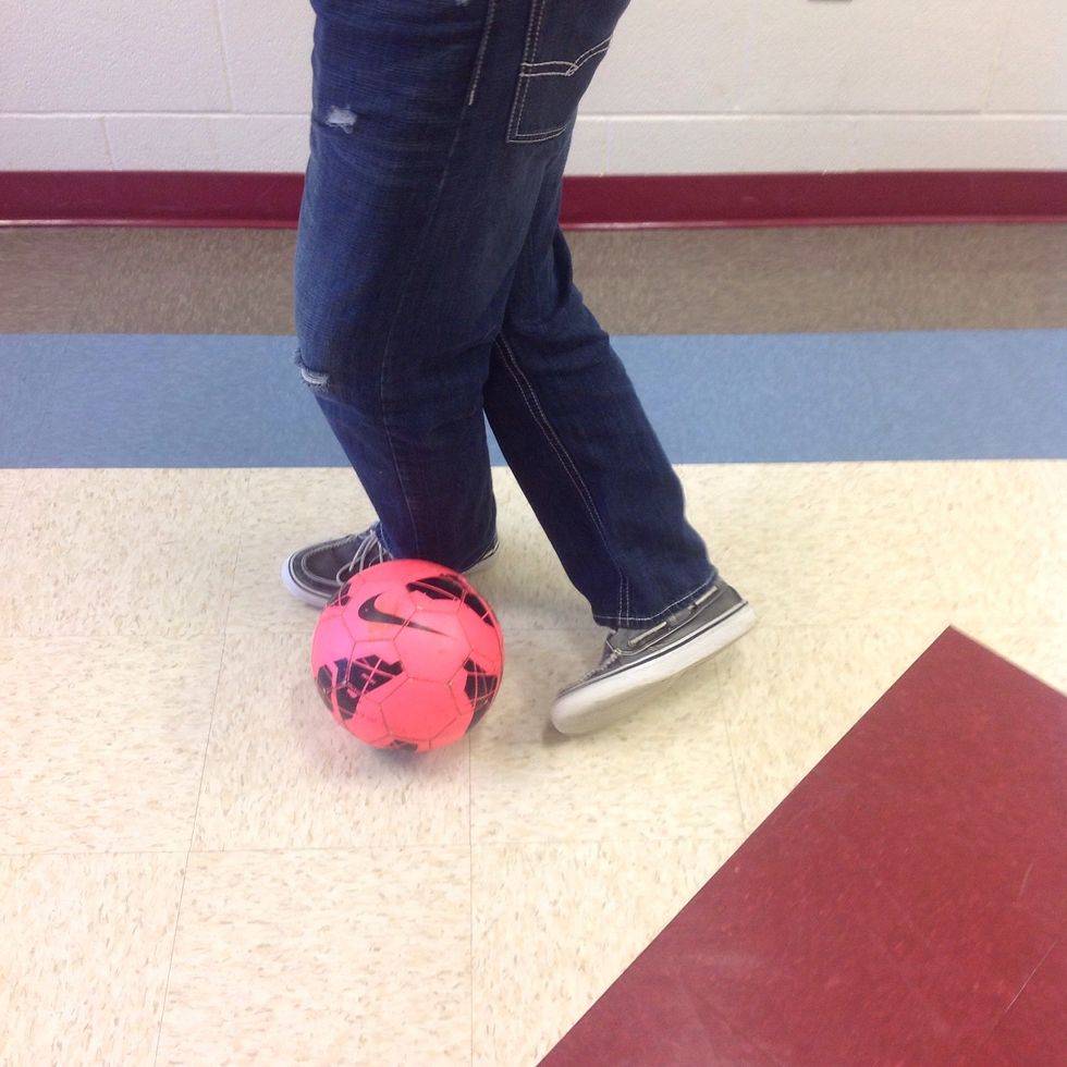 Curl your foot to kick the ball with the top of your boot