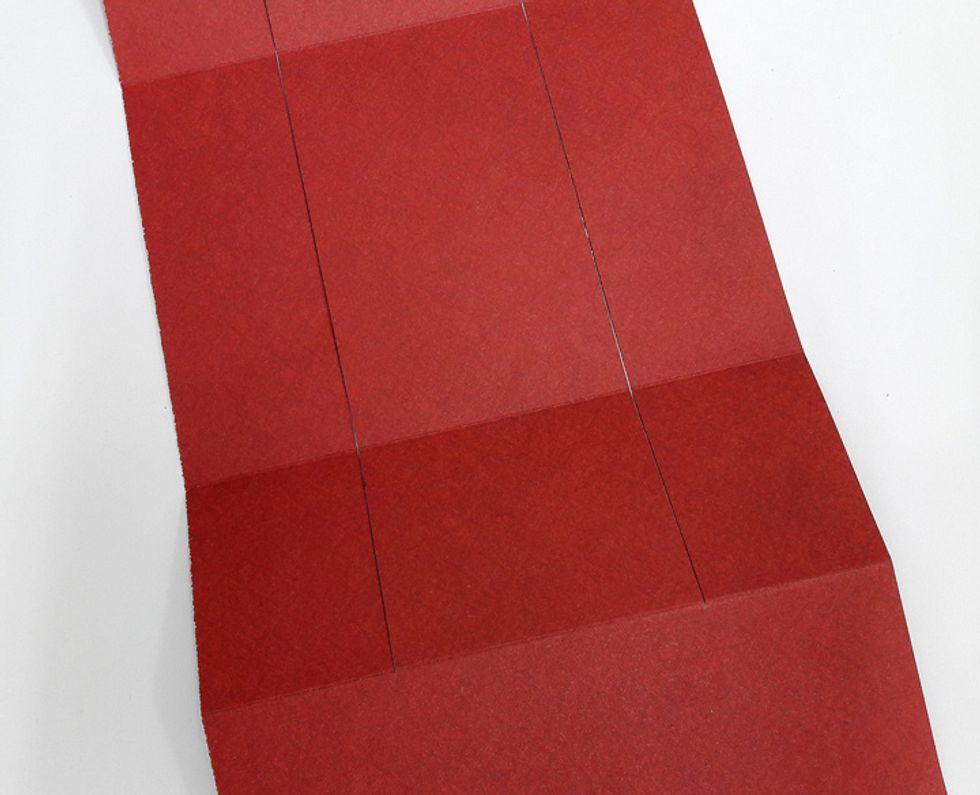 Cut 1 1/2" from the edge starting on 2" fold to 10" fold. Repeat on other side.
