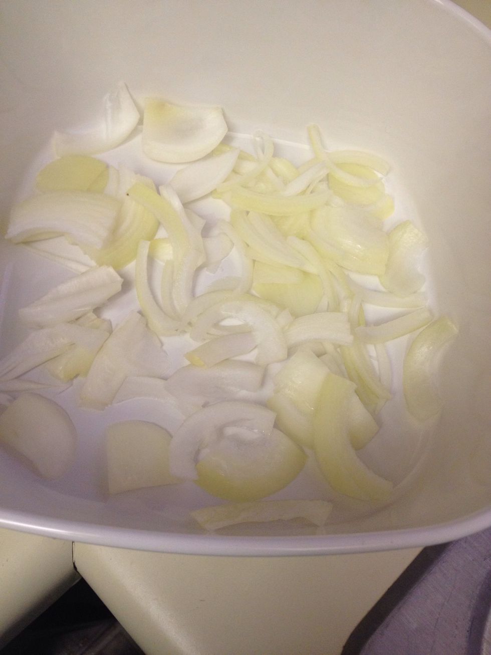 Cut 1/2 of the last onion and layer onto the bottom of your casserole dish.