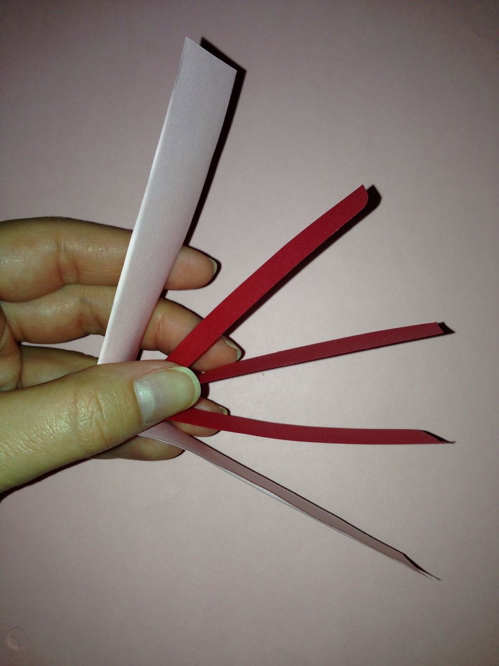 Cut 1/2" paper strips. Start with 4 strips of paper. Staple. The paper can be a thick as you'd like but I found that the shorter the paper the more uniform the heart. I used 3" strips and 6" strips.