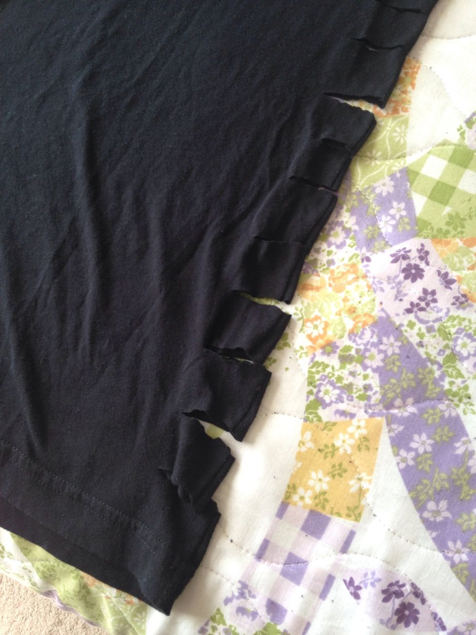 Cut 1 inch slits along both sides of the shirt.