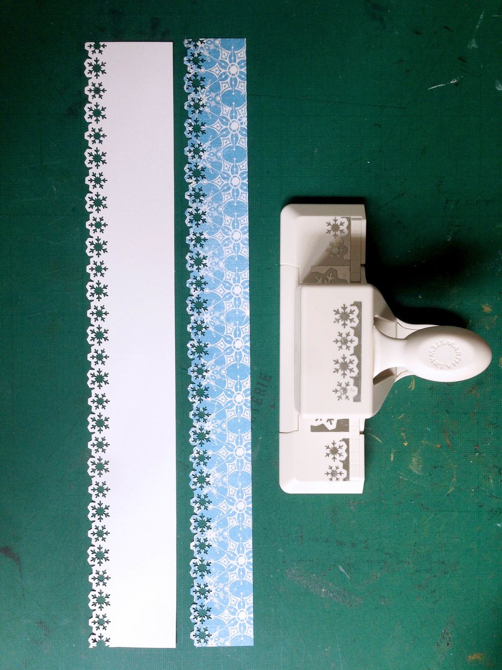 Cut 12" strips of 1.5" from white cardstock & 1.25" from Snowflake Waltz paper... Punch the edges with snowflake punch... Mini snowflakes will come off from the punch which you can use as confetti...