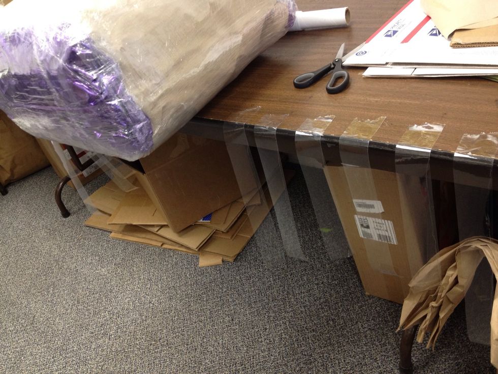 Cut 12 x 8-10" long strips of tape and secure the corners of the package by stretching them across the corner (3 for each corner) in an asterisk pattern.