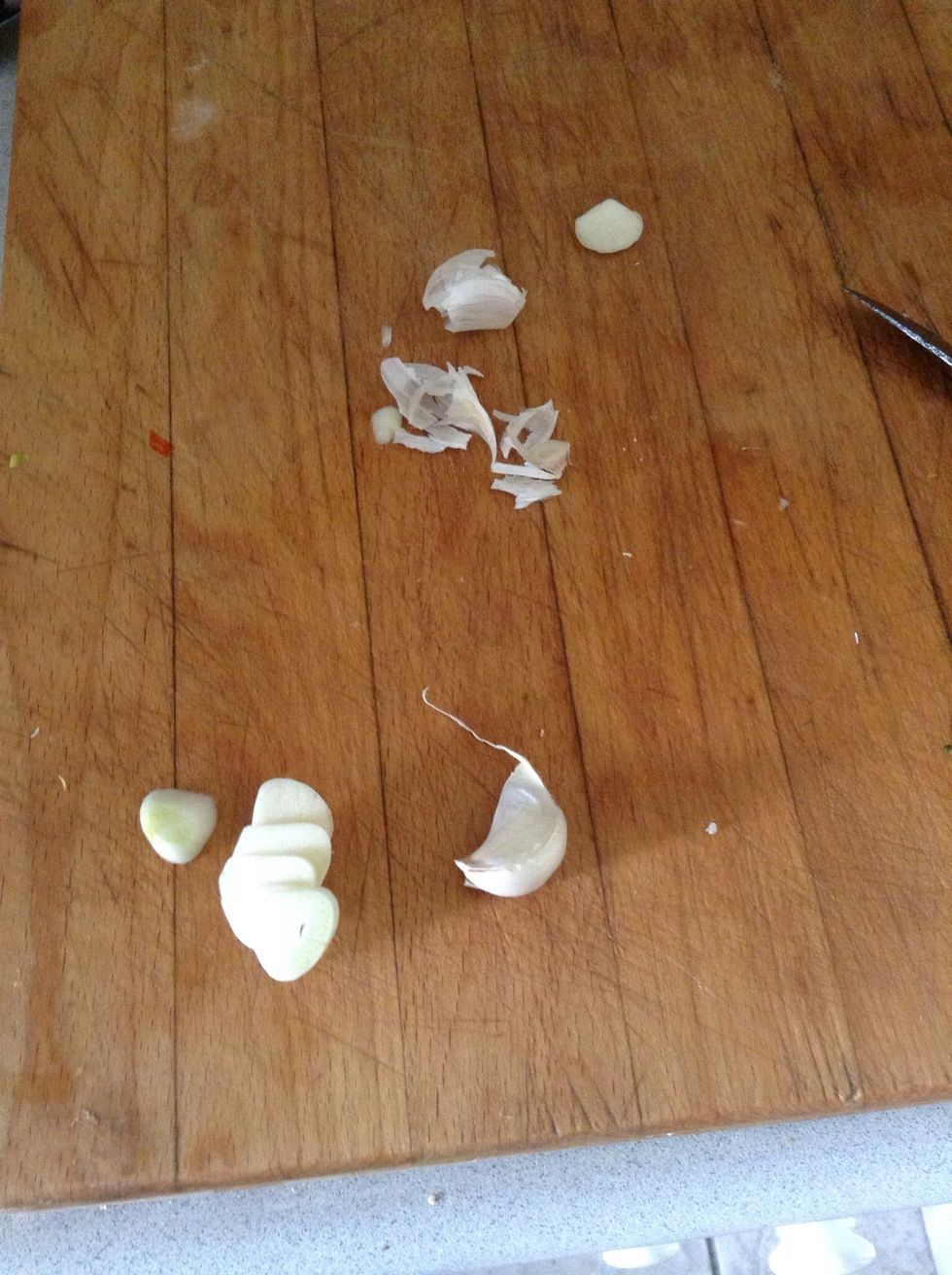 Cut 2 garlic cloves into slices