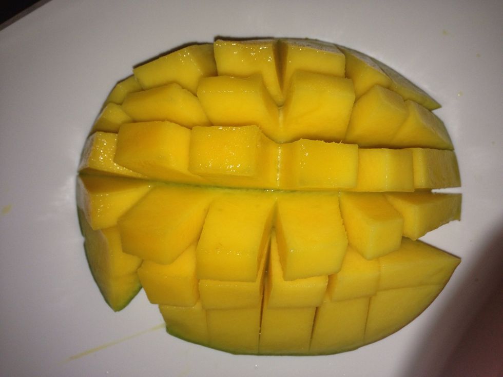 Cut 2 mangoes. This short cut way of cutting the mangoes into small cubes. I scooped the mango flesh with a spoon.