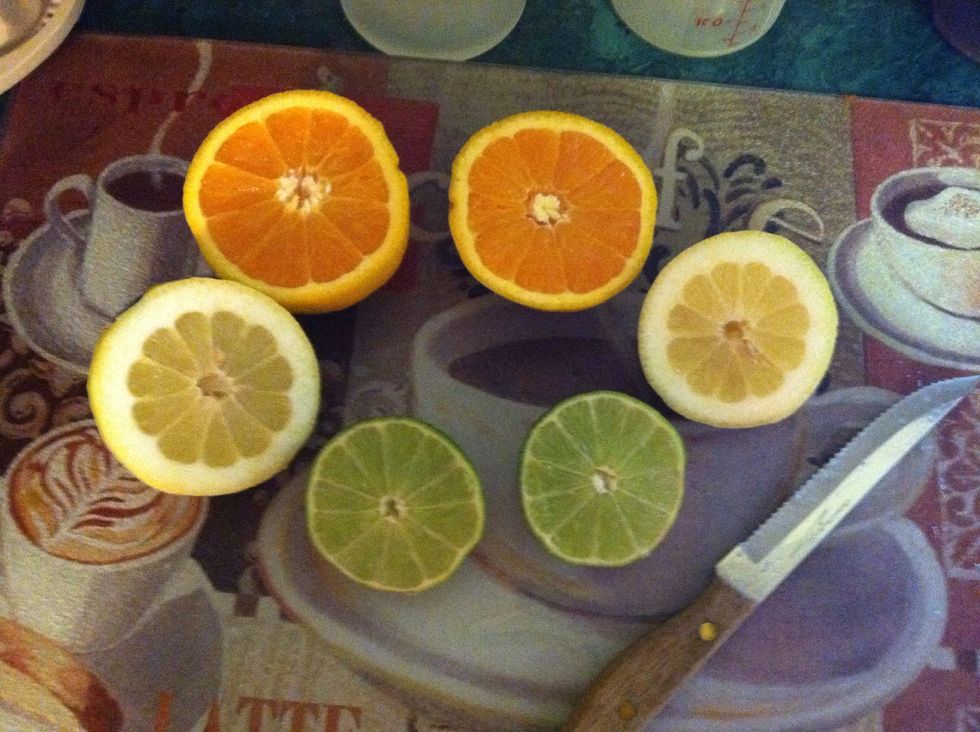 Cut 2 oranges, 1 lemon and 1 lime in half