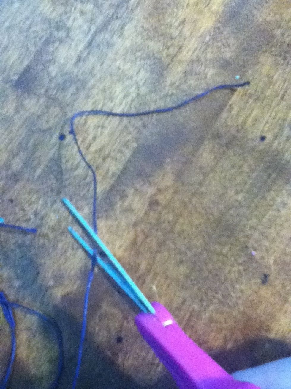 Cut 2 pieces of the string at the same length that fit around your wrist comfortably