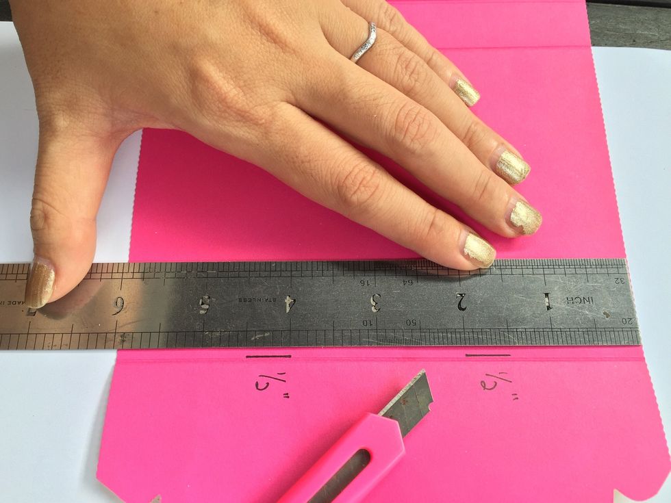 Cut 2 slits of 0.5" on the flap end of the paper so as to slit the grosgrain ribbon through as a "handle" of the purse.