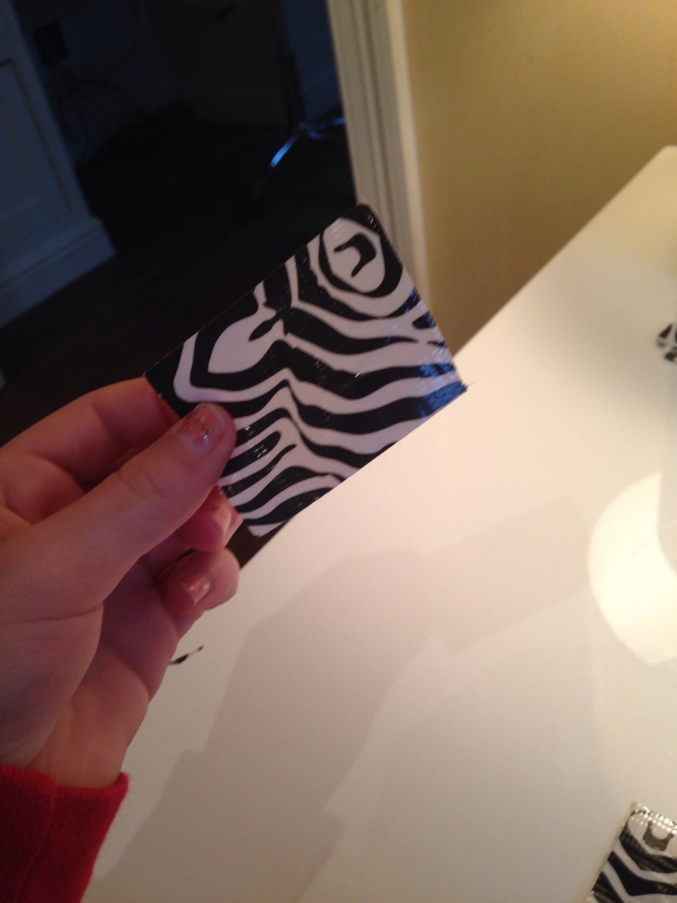 Cut 2 squares of tape like this