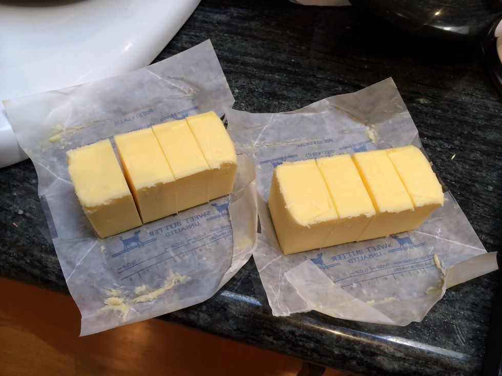 Cut 2 sticks of room temperature butter into smaller pieces.