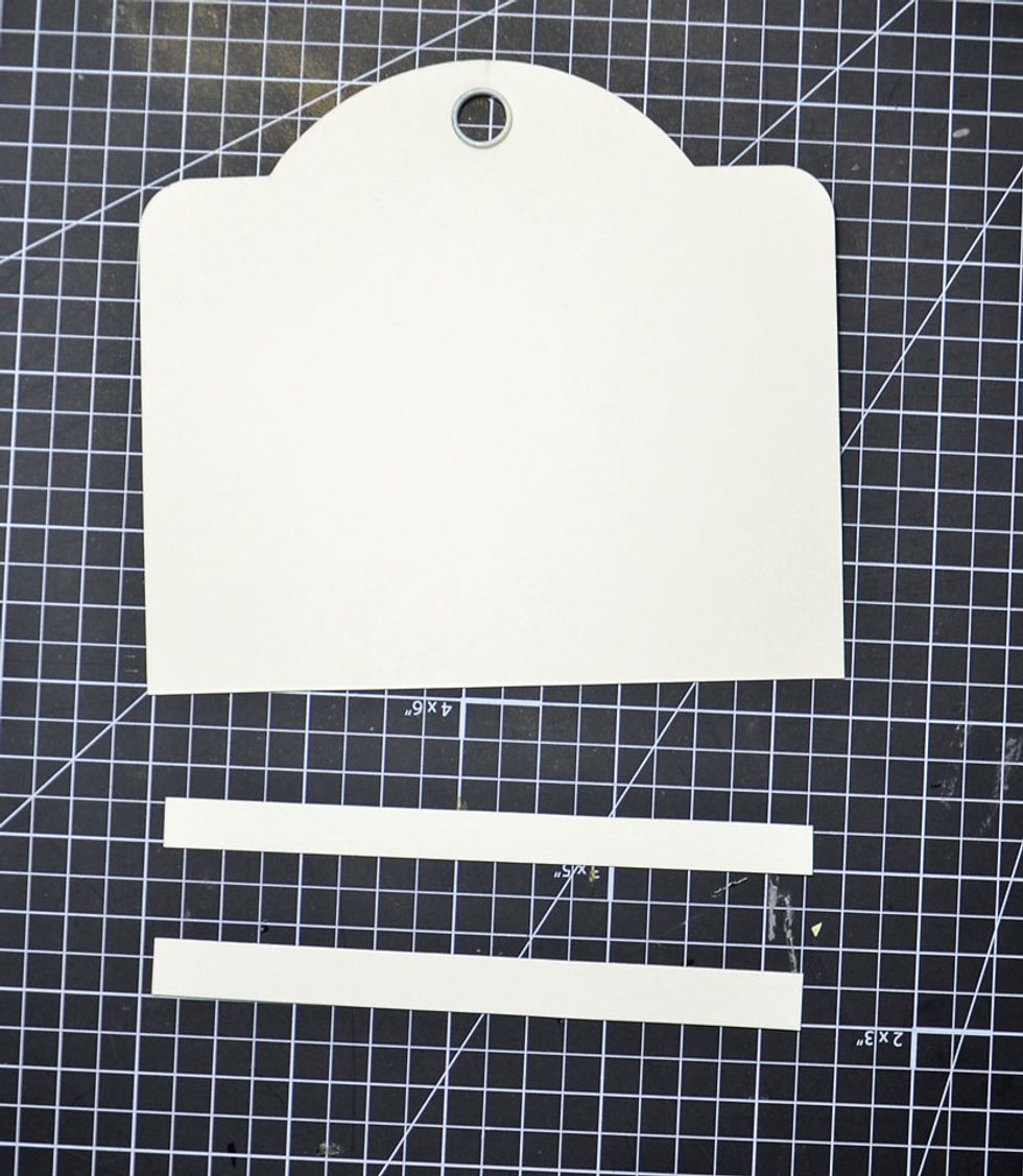 Cut 2 strips of Cardstock approximately 1cm wide and just under the full width of the large square tag as shown.