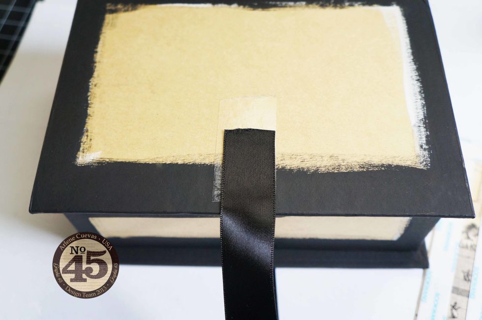 Cut 2 strips of ribbon (approx. 10-12 inches each in length). Adhere the end of one ribbon strip to the ScorTape as shown.