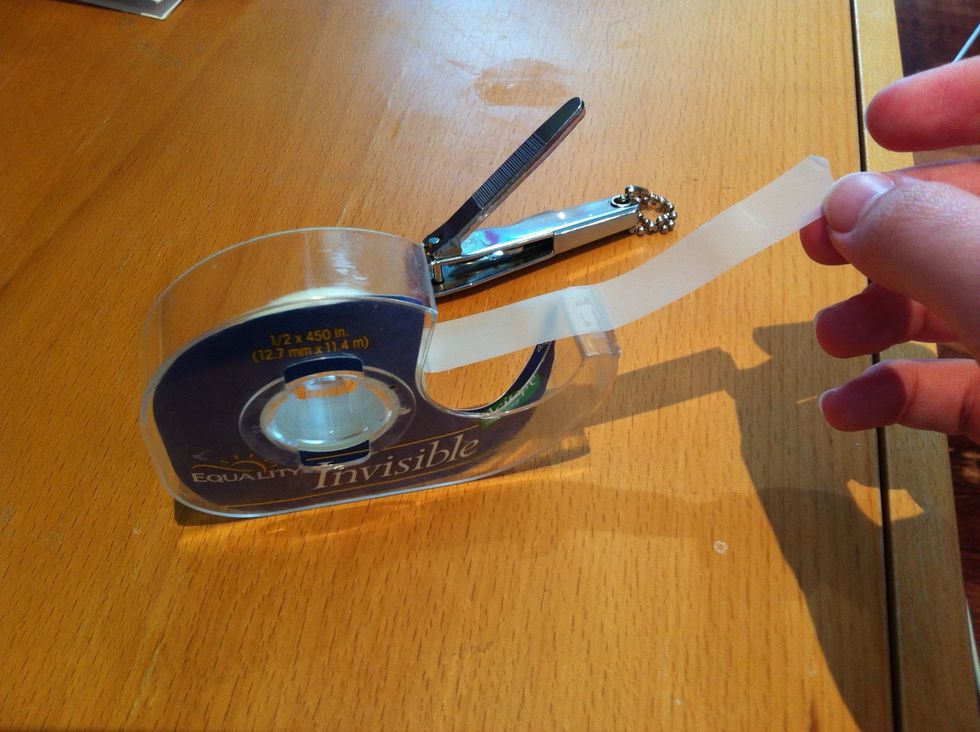 Cut 2 strips of tape, long enough to cover the open sides of your nail clipper. Invisible tape yea right ..