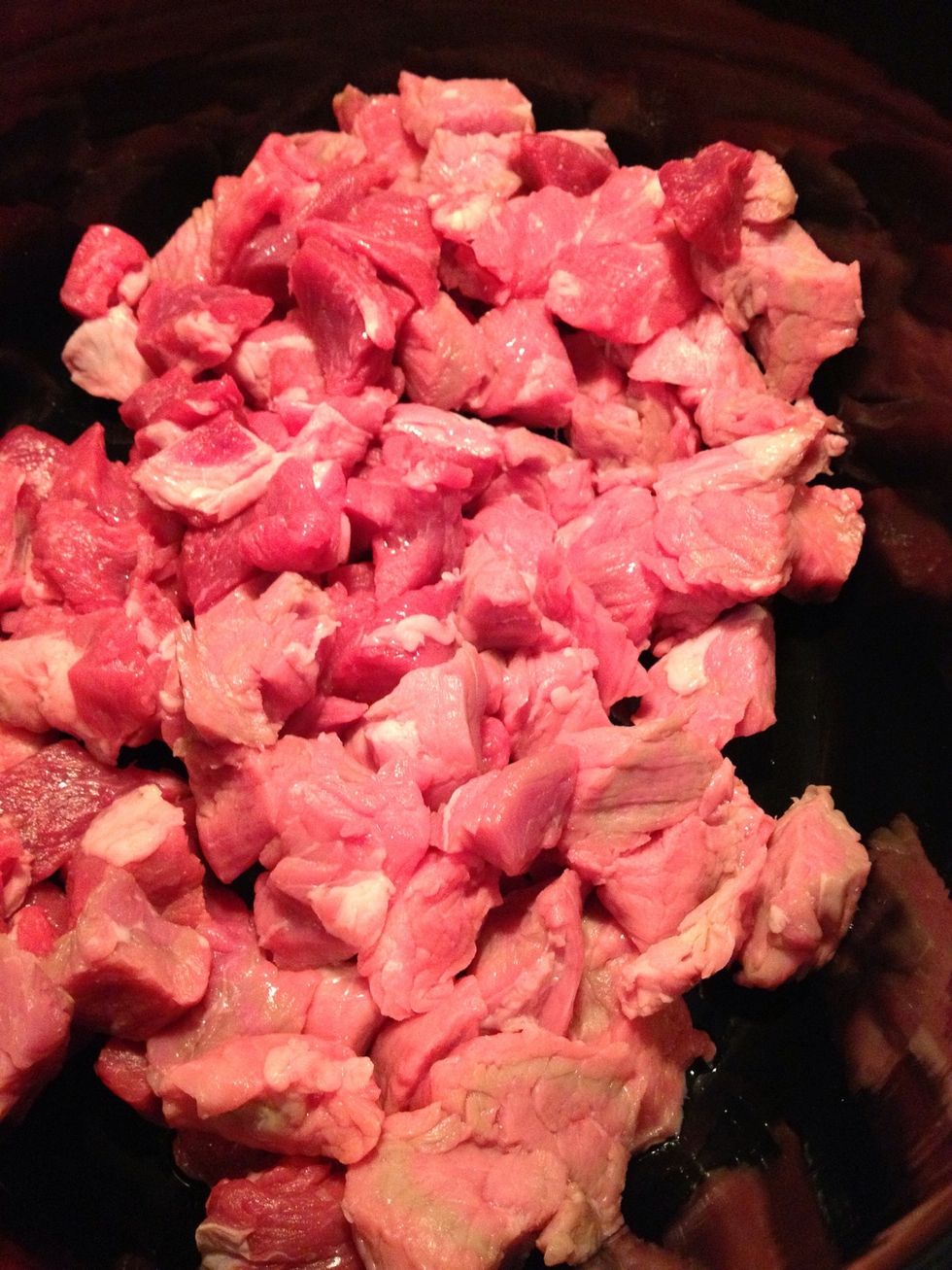 Cut 2lbs of beef into appx 1-inch cubes & place in a crock pot. This is a 6-qt pot. I just use the beef already packaged for stew that you find at your grocery store.