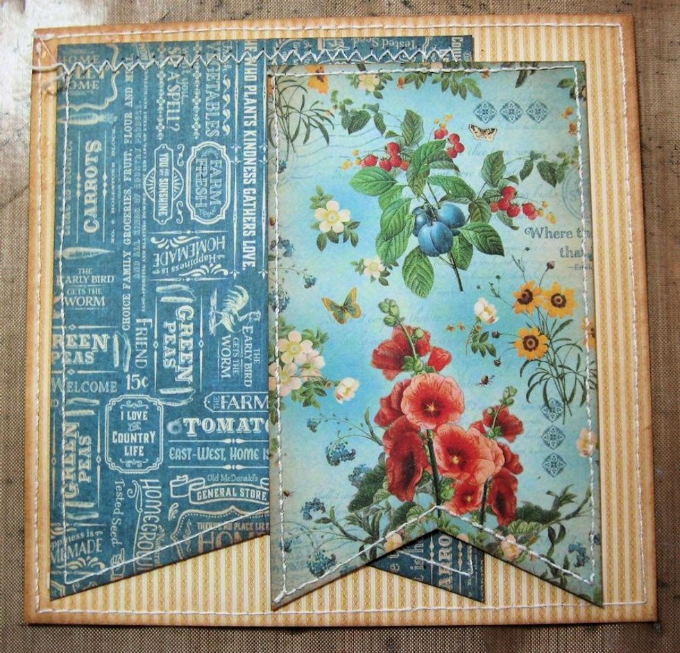 Cut 3" x 4.75" banner flag from patterned paper. stitch if desired and glue in place as shown.