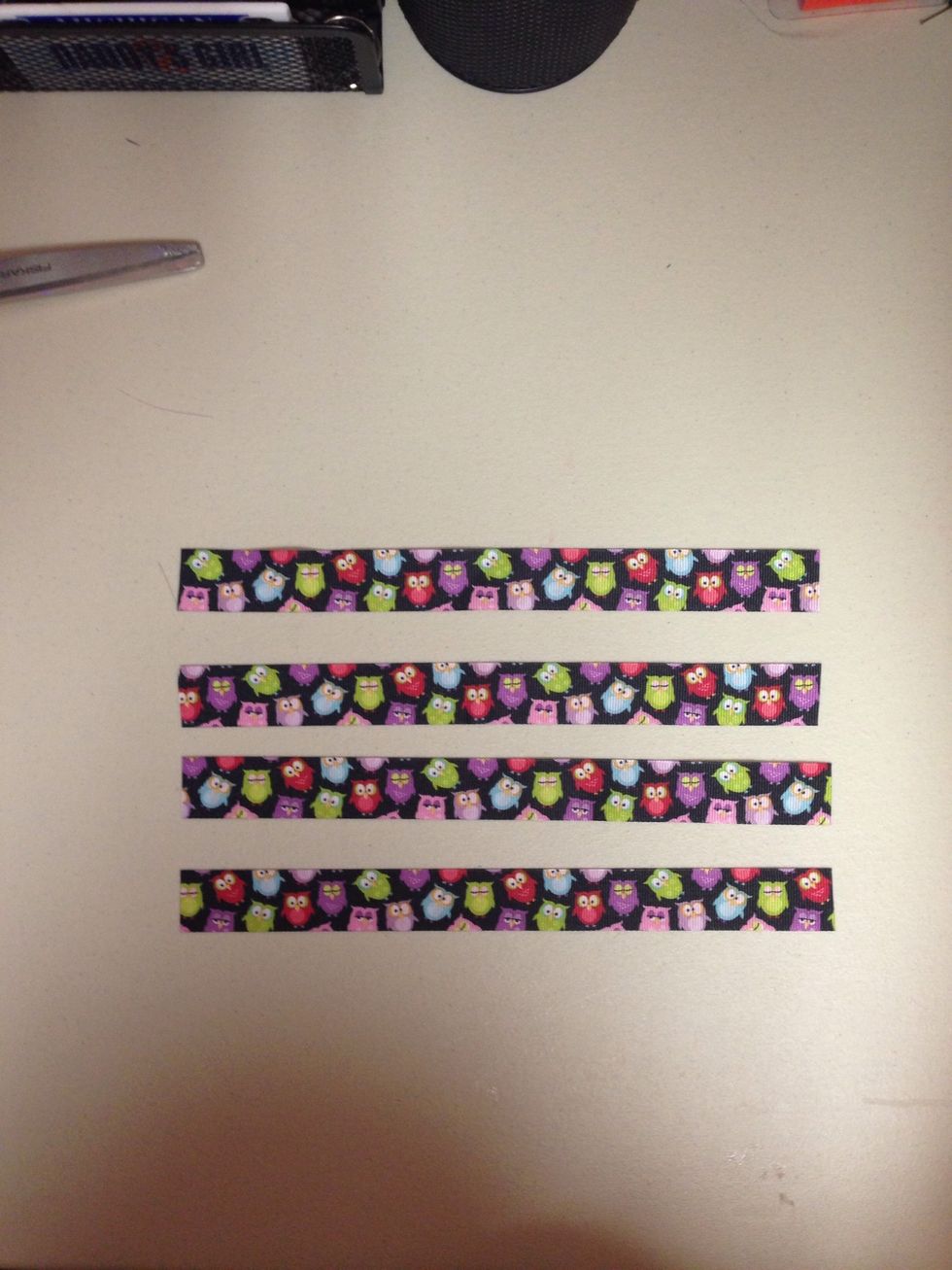 Cut 4, 9 1/4 in inches of ribbon, heat seal