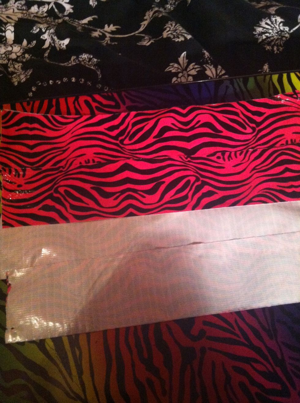 cut 4 more pieces the same length in my case 10", place It on top of your other four pieces sticky side to sticky side like I am doing here until you have a sheet of duck tape with print on both sides