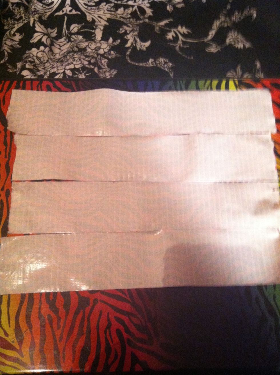cut 4 pieces of duck tape to about 10" put sticky side up that will make your wallet about the same size as a typical wallet if you would like your wallet bigger or smaller feel free to change.