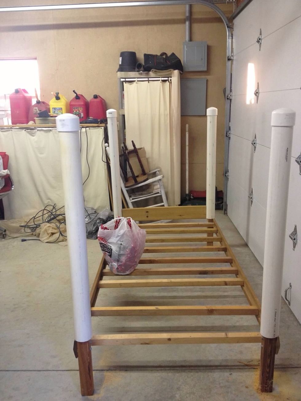 Cut 4 PVC pipes equal lengths. Top with caps. Slide pipes over corner bed poles. Drill 3 holes equal lengths apart down each pipe where the ropes will go.