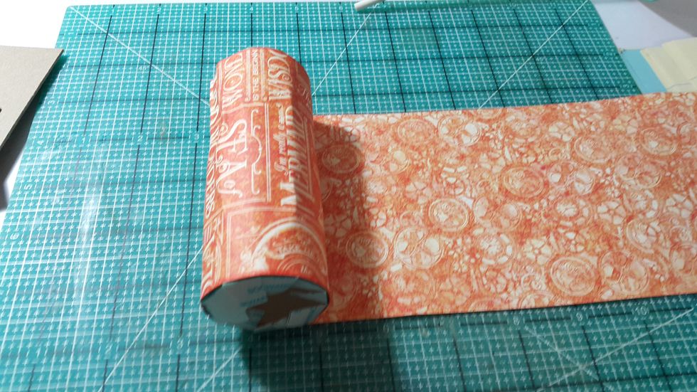 Cut 4 strips of 4-1/4" height papers (12" long each), connect them one by one, then adhere the start on the toilet tissue roll.