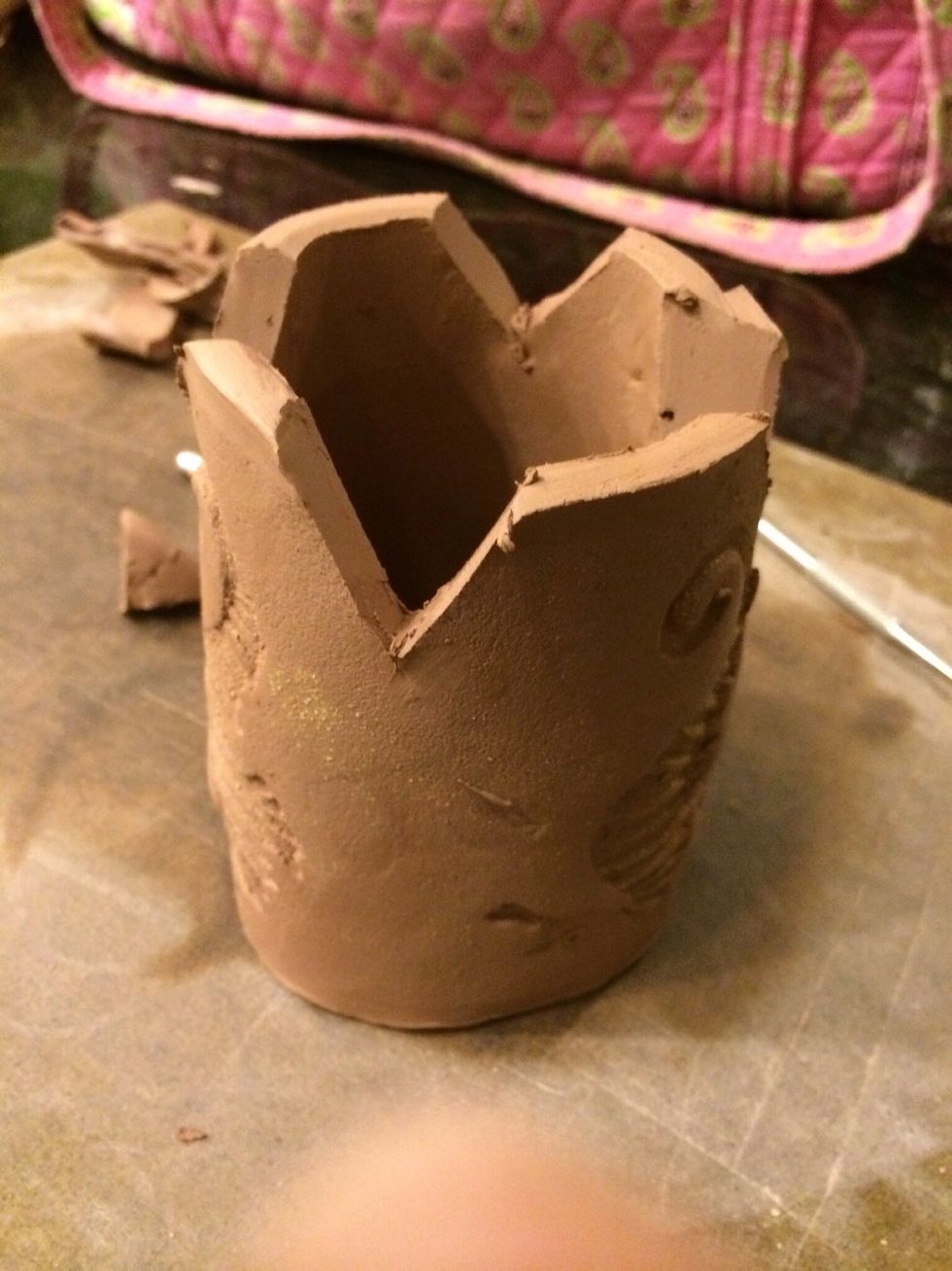 Cut 4 triangles into your clay where you measured out. These will be folded together to create the bottom of the cup.