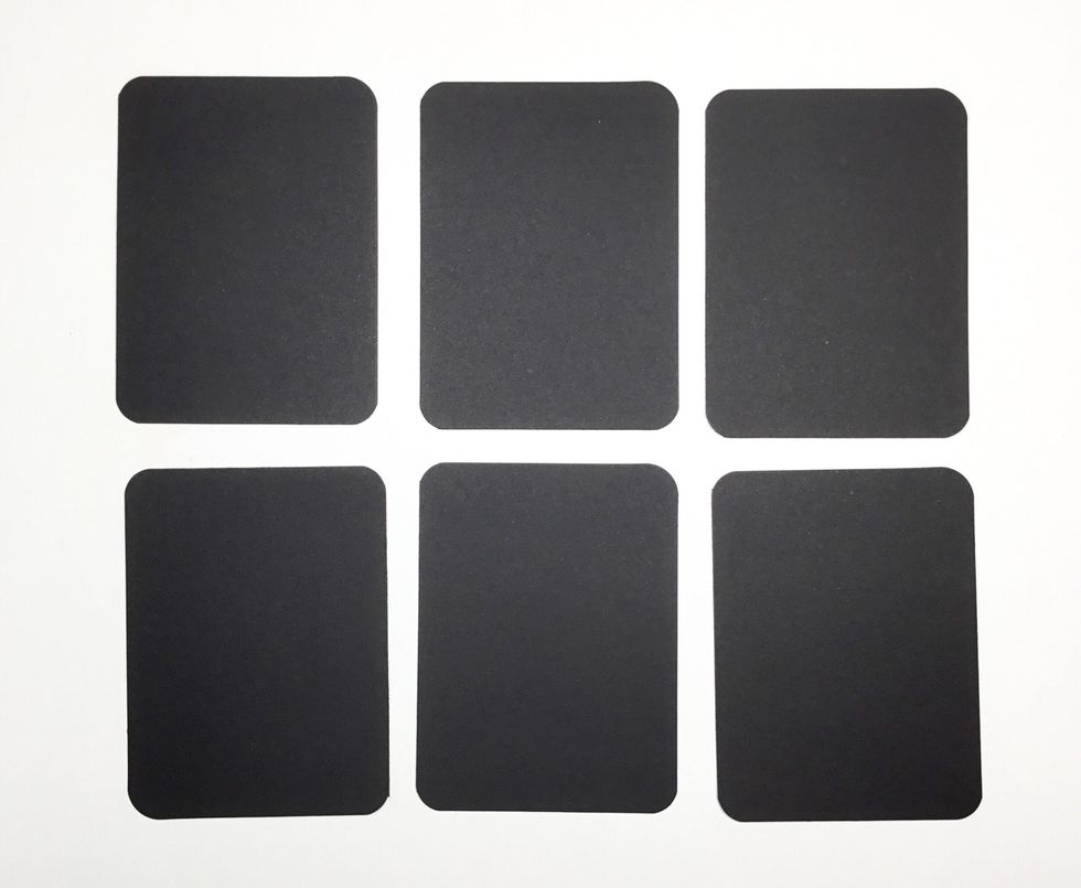 Cut 6 black cardboard rectangles measuring 7.5cm x 10cm. I have used the Graphic 45 Regular tags for this step. Once cut round all corners with a corner punch.