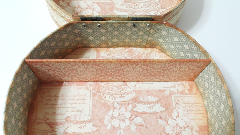 Cut 7-1/4"x2" chipboard, cover with paper, glue inside the box as compartment