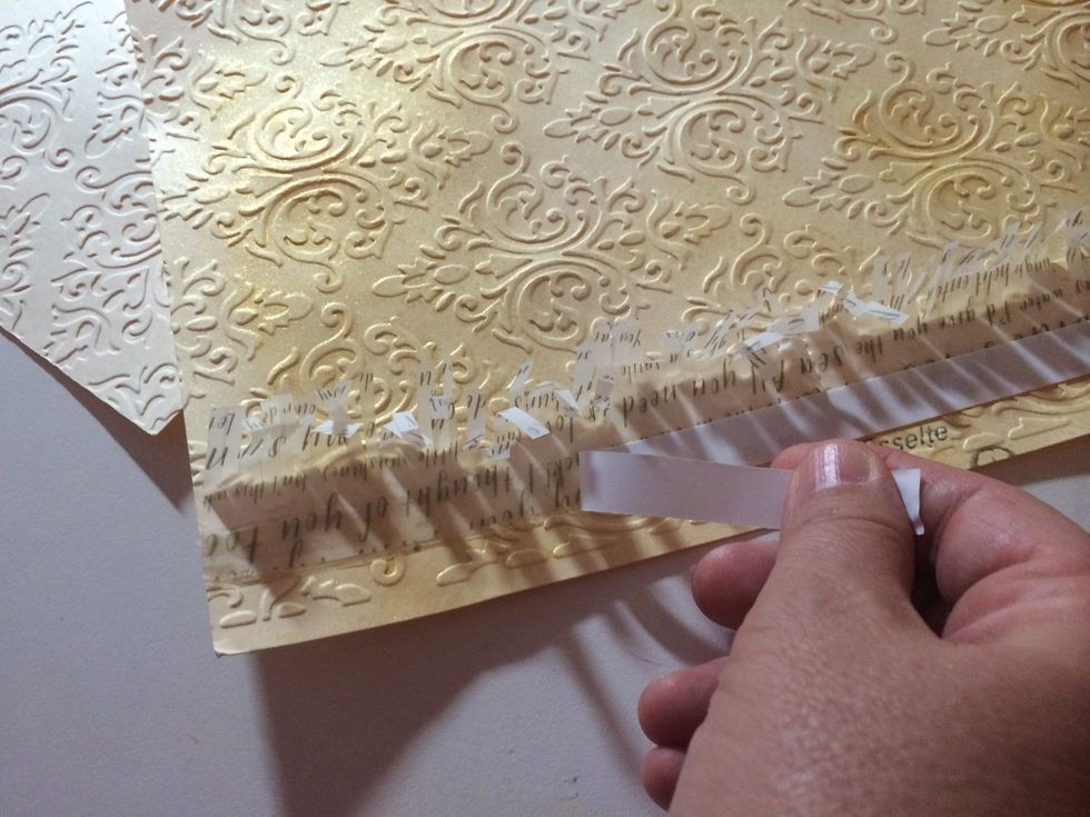 Cut a 1 1/2" strip of Sheer Metallic vellum, cut fringe on one side. Adhere (double sided high tack tape)uncut side to left side of file folder front cover. Adhere another strip of double sided tape.