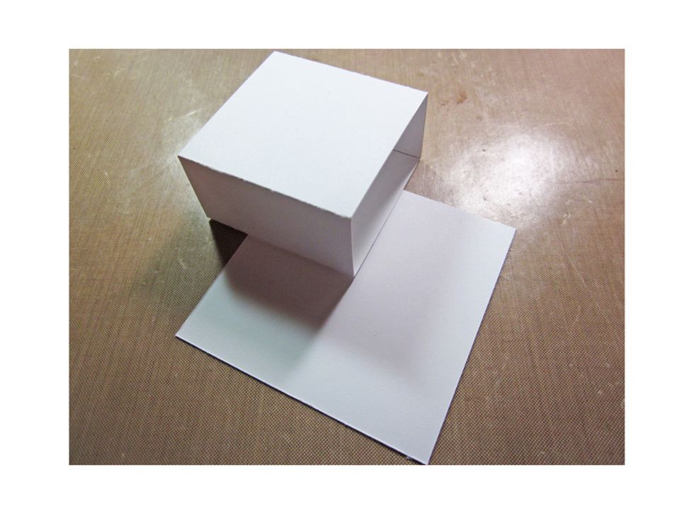 Cut a 3 x 3" square and glue down your drawer sleeves flipping the boxes so the openings alternate.