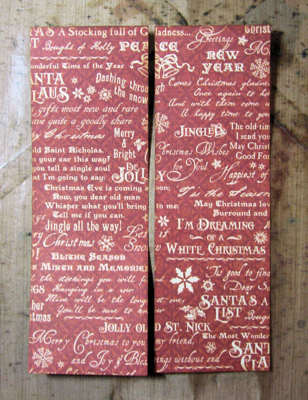 Cut a 4 5/8" x 6 5/8" rectangle from Kris Kringle paper. Cut down the middle to create two long rectangles. These will be matted on the silver cardstock layer. I always ink all my cut edges.