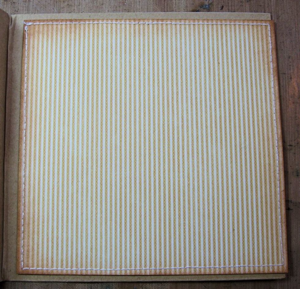 Cut a 5.75" square of yellow stripes from 6x6" prints and patterns. If desired, machine stitch around the edges with ivory thread. Do not glue cover onto album until all inner pages are complete!