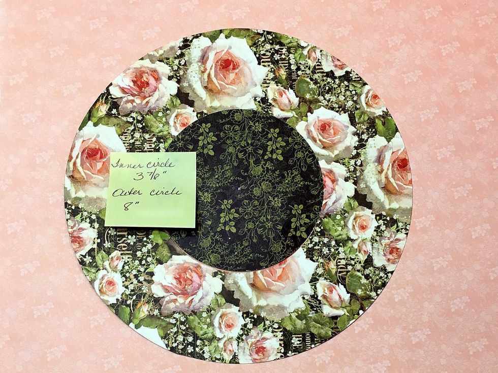 Cut a 8" in diameter circle and cut out frome the center, a 3 7/8" circle as shown. Discard the inner circle.