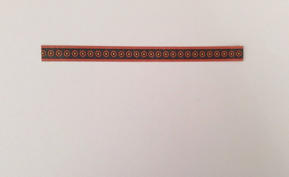 Cut a border strip from the paper collection to 6 inches in length and ink edges with a black marker to hide white paper core.