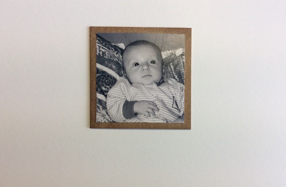 Cut a chosen photo down to size measuring 2 x 2 inches and adhere to chipboard piece 2