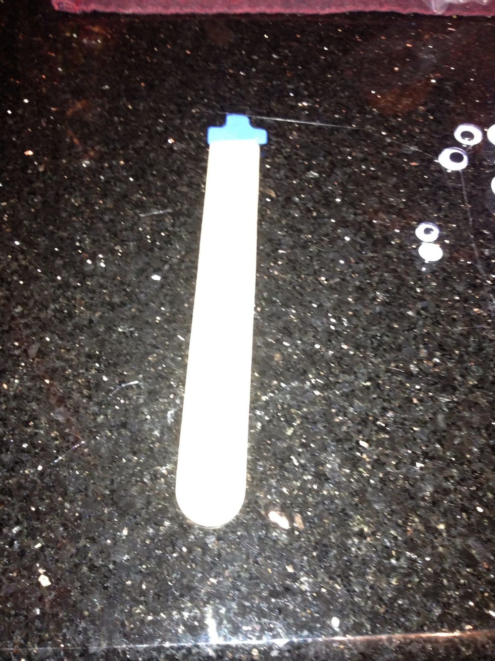 Cut a hat out of fun foam and glue it to one end of the craft stick.
