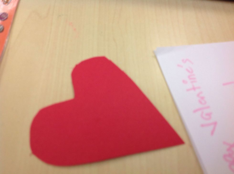Cut a heart out of red paper.