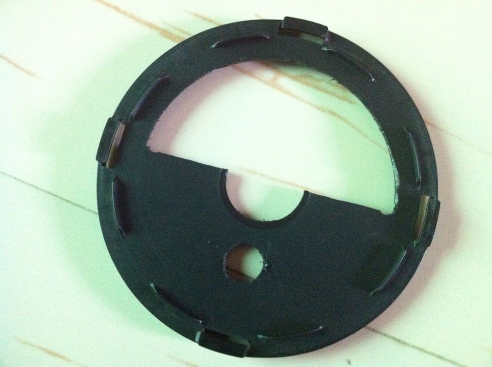 Cut a hole of the size of the rod on the bottom part. Do it right below the big hole from where you cut the rod out. Make a bigger hole above the middle hole. The bottom part should look like this.