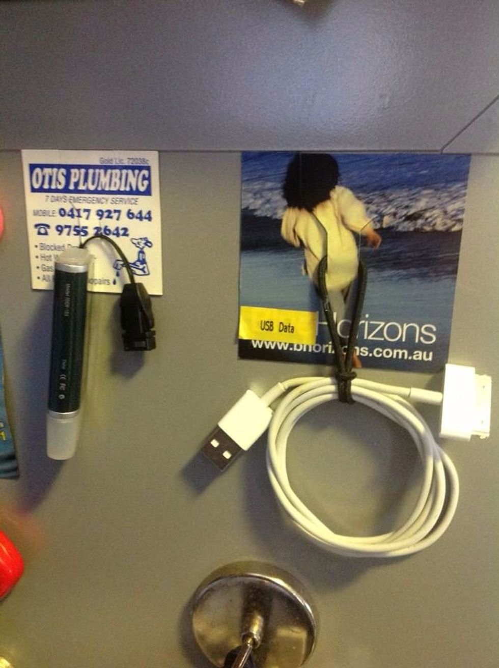 Cut a hook shape INSIDE flat, advertising 'fridge' magnets.  Ensure, 1. there's enough magnet at the top to secure the hanging item once returned to a ferrous surface.  See next...