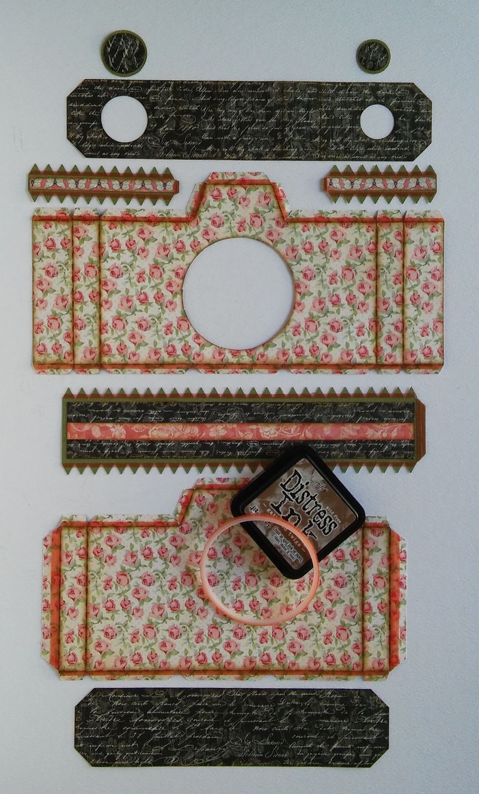 Cut a large camera from the 3 Mon Amour sheets using your Silhouette. Ink the edges with distress ink and add double sided tape to the tabs where necessary.