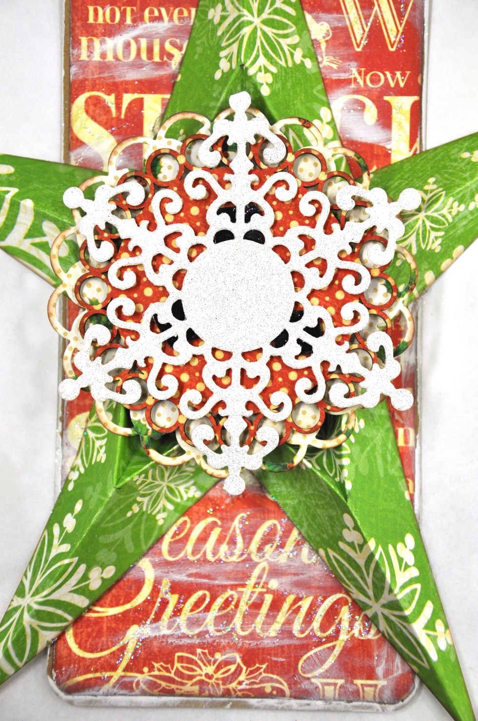 Cut a large snowflake out of the glitter sheet and use foam squares to attach it.