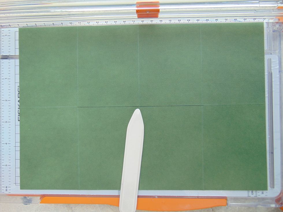 Cut a line horizontally from the 2 3/4" score line to the 8 1/4" score line.