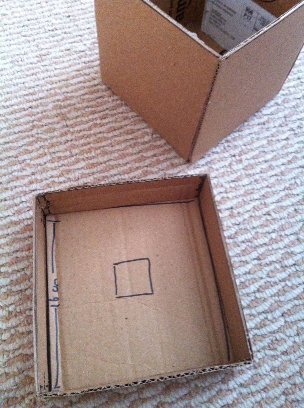 Cut a little square in the middle of the lid to be the opening for the tissue to come out.