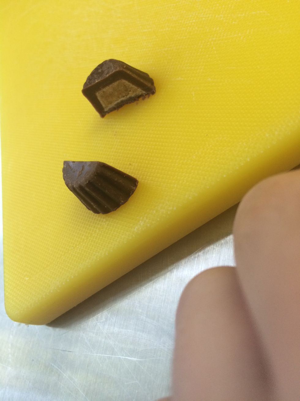 Cut a mini Reese's cup in 1/2.