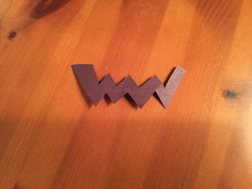 Cut a mouth out of the black paper, it can be personalized.