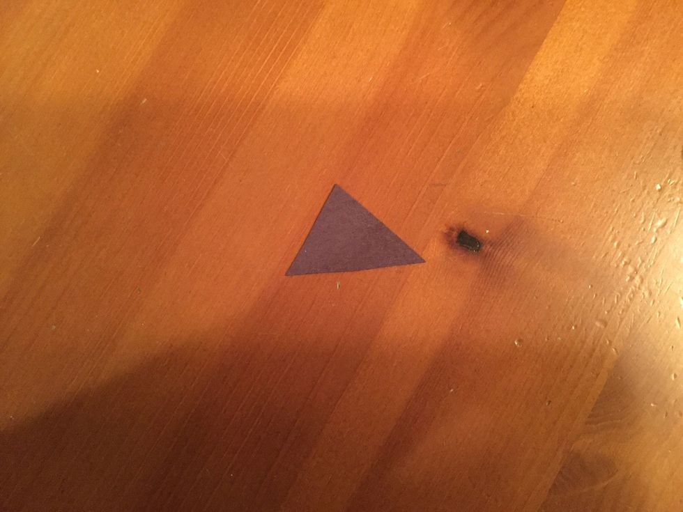 Cut a nose out of the black paper, it doesn't have to be triangular.